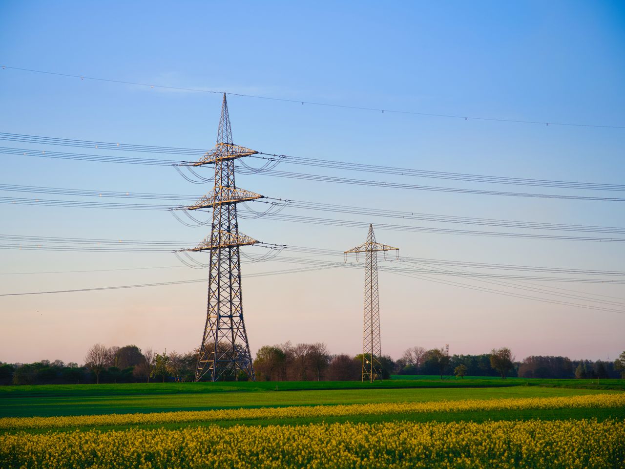 Crafting Captivating Headlines: Your awesome post title goes here Dusk landscape showing transmission towers and lush fields under a clear sky.